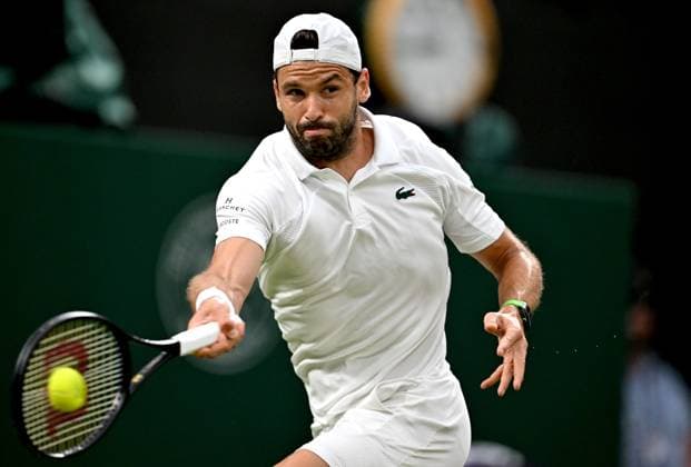 (250708) -- LONDON, July 8, 2025 -- Grigor Dimitrov hits a return during the men s singles round of 16 match between Grigor Dimitrov of Bulgaria and Jannik Sinner of Italy at the Wimbledon Tennis Championships in London, Britain, July 7, 2025. ) (SP)BRITAIN-LONDON-TENNIS-WIMBLEDON-MEN S SINGLES LixYing 