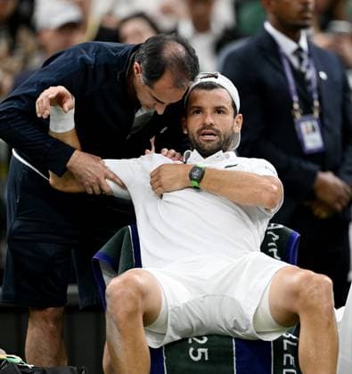 (250708) -- LONDON, July 8, 2025 -- Grigor Dimitrov (R) receives medical help after getting injured during the men s singles round of 16 match between Grigor Dimitrov of Bulgaria and Jannik Sinner of Italy at the Wimbledon Tennis Championships in London, Britain, July 7, 2025. ) (SP)BRITAIN-LONDON-TENNIS-WIMBLEDON-MEN S SINGLES LixYing 