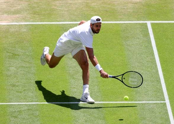 8th July 2025; All England Lawn Tennis and Croquet Club, London, England; Wimbledon Tennis Tournament, Day 9; Karen Khachanov (RUS) with a backhand shot toTaylor Fritz (USA), mens singles quarter-final match  ActionPlus12811392 JohnxPatrickxFletcher