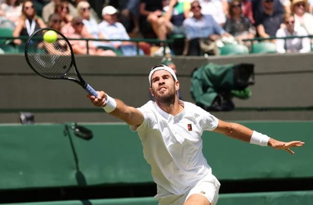 American Taylor Fritz plays a forehand in his Quarter-Final match against Karen Khachanov on day nine of the 2025 Wimbledon Championships in London on Tuesday, July 08, 2025.  LON2025070805 HUGOxPHILPOTT