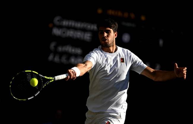 (250709) -- LONDON, July 9, 2025 -- Carlos Alcaraz hits a return during the men s singles quarterfinal match between Carlos Alcaraz of Spain and Cameron Norrie of Britain at the Wimbledon Tennis Championships in London, Britain, July 8, 2025. ) (SP)BRITAIN-LONDON-TENNIS-WIMBLEDON-MEN S SINGLES LixYing 