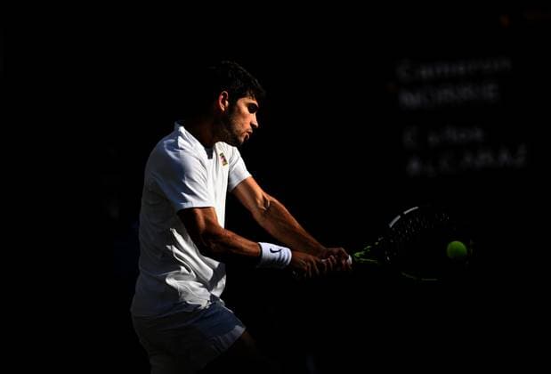 (250709) -- LONDON, July 9, 2025 -- Carlos Alcaraz hits a return during the men s singles quarterfinal match between Carlos Alcaraz of Spain and Cameron Norrie of Britain at the Wimbledon Tennis Championships in London, Britain, July 8, 2025. ) (SP)BRITAIN-LONDON-TENNIS-WIMBLEDON-MEN S SINGLES LixYing 