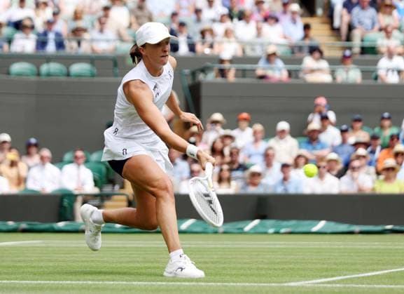 Poland s Iga Swiatek plays a forehand in her Quarter-Final match against Liudmilla Samsonova on day ten of the 2025 Wimbledon Championships in London on Wednesday, July 09, 2025.  LON2025070920 HUGOxPHILPOTT