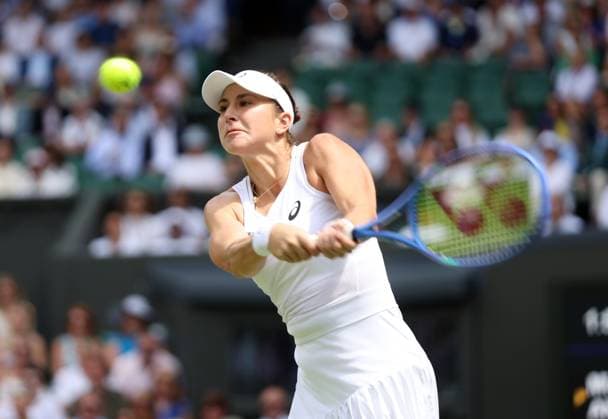 Switzerland s Belinda Bencic plays a backhand in her Quarter-Final match against Mirra Andreeva on day ten of the 2025 Wimbledon Championships in London on Wednesday, July 09, 2025.  LON2025070923 HUGOxPHILPOTT