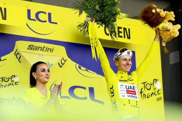 Slovenian Tadej Pogacar of UAE Team Emirates celebrates on the podium in the yellow jersey of leader in the overall ranking after stage five of the 2025 Tour de France cycling, a 33km time trial in Caen, France on Wednesday 09 July 2025. The 112th edition of the Tour de France starts on Saturday 5 July in Lille, France, and will finish in Paris, France on the 27th of July. DAVIDxPINTENS  x128773438x