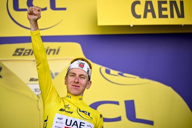 Slovenian Tadej Pogacar of UAE Team Emirates celebrates on the podium in the yellow jersey of leader in the overall ranking after stage five of the 2025 Tour de France cycling, a 33km time trial in Caen, France on Wednesday 09 July 2025. The 112th edition of the Tour de France starts on Saturday 5 July in Lille, France, and will finish in Paris, France on the 27th of July. JASPERxJACOBS  x128773507x