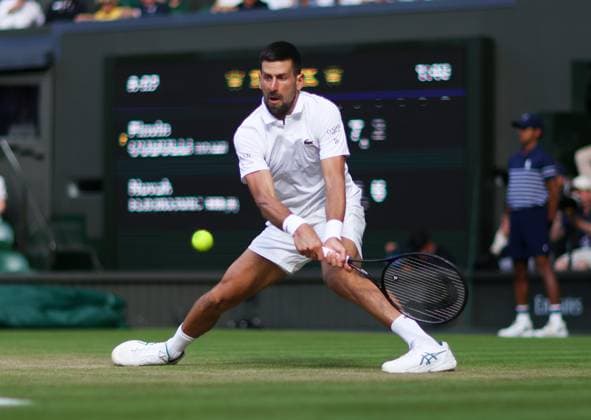 Wimbledon Championships 2025 AELTC, Day Ten, London, UK - 09 07 2025 Novak Djokovic (SRB) in action during his quarter final match against Flavio Cabolli (ITA) in the 2025 Wimbledon Championships London Wimbledon London GBR, UK NEWSPAPERS OUT Copyright: xMarkxGreenwoodx