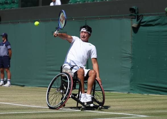 9th July 2025; All England Lawn Tennis and Croquet Club, London, England; Wimbledon Tennis Tournament, Day 10; Zhenxu Ji (CHN) with a backhand shot to Alfie Hewett (GBR) in their mens wheelchair singles quarter-final  ActionPlus12811992 JohnxPatrickxFletcher