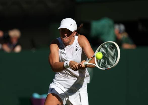 10th July 2025; All England Lawn Tennis and Croquet Club, London, England; Wimbledon Tennis Tournament, Day 11; Iga Swiatek (POL) with a backhand shot to Belinda Bencic (SUI), during their womens singles semi-final match  ActionPlus12812205 JohnxPatrickxFletcher