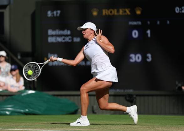 10th July 2025; All England Lawn Tennis and Croquet Club, London, England; Wimbledon Tennis Tournament, Day 11; Iga Swiatek (POL) with a forehand shot to Belinda Bencic (SUI) , during their womens singles semi-final match  ActionPlus12812183 JohnxPatrickxFletcher