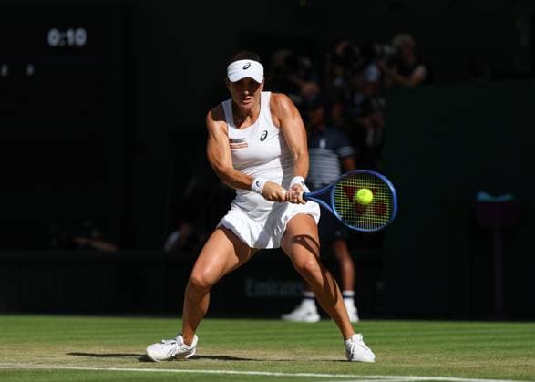 10th July 2025; All England Lawn Tennis and Croquet Club, London, England; Wimbledon Tennis Tournament, Day 11; Belinda Bencic (SUI) with a backhand shot to Iga Swiatek (POL) , during their womens singles semi-final match  ActionPlus12812184 JohnxPatrickxFletcher