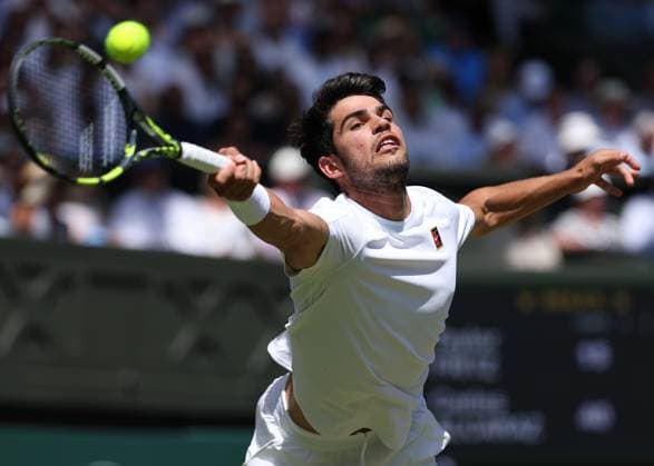 11th July 2025; All England Lawn Tennis and Croquet Club, London, England; Wimbledon Tennis Tournament, Day 12; Carlos Alcaraz (ESP) stretches for a forehand shot to Taylor Fritz (USA) mens singles semi-final  ActionPlus12812289 JohnxPatrickxFletcher