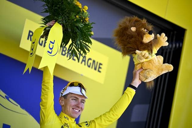 Slovenian Tadej Pogacar of UAE Team Emirates celebrates on the podium in the yellow jersey of leader in the overall ranking after stage seven of the 2025 Tour de France cycling, from Saint-Malo to Mur-de-Bretagne (194 km), on Friday 11 July 2025 in France. The 112th edition of the Tour de France starts on Saturday 5 July in Lille, France, and will finish in Paris, France on the 27th of July. POOLxLUCAxBETTINI  x128905524x