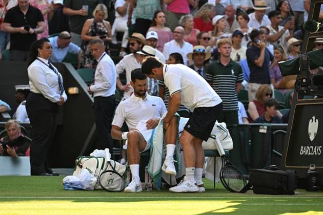 (250712) -- LONDON, July 12, 2025 -- Novak Djokovic (front L) gets medical treatments during the men s singles semifinal match between Jannik Sinner of Italy and Novak Djokovic of Serbia at the Wimbledon Tennis Championships in London, Britain, July 11, 2025. ) (SP)BRITAIN-LONDON-TENNIS-WIMBLEDON-MEN S SINGLES ZhaoxDingzhe 