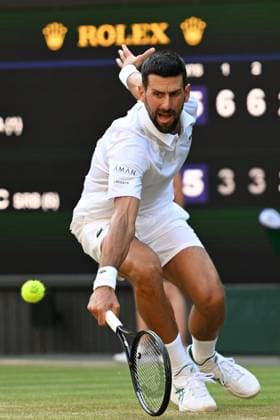 (250712) -- LONDON, July 12, 2025 -- Novak Djokovic hits a return during the men s singles semifinal match between Jannik Sinner of Italy and Novak Djokovic of Serbia at the Wimbledon Tennis Championships in London, Britain, July 11, 2025. ) (SP)BRITAIN-LONDON-TENNIS-WIMBLEDON-MEN S SINGLES ZhaoxDingzhe 