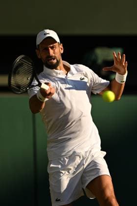 (250712) -- LONDON, July 12, 2025 -- Novak Djokovic hits a return during the men s singles semifinal match between Jannik Sinner of Italy and Novak Djokovic of Serbia at the Wimbledon Tennis Championships in London, Britain, July 11, 2025. ) (SP)BRITAIN-LONDON-TENNIS-WIMBLEDON-MEN S SINGLES ZhaoxDingzhe 