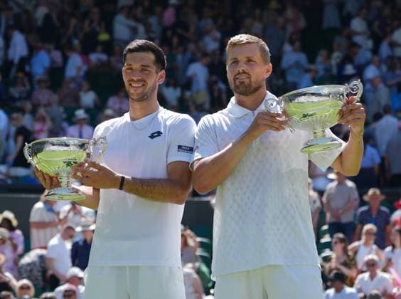 Tennis - 2025 Wimbledon Championships - Mens Doubles Final - Winky Hijikata and David Pel v Julian Cash and Lloyd Glasspool All England Lawn Tennis & Croquet Club - Saturday 12th July 2025 Julian Cash and Lloyd Glasspool with their winners trophies 