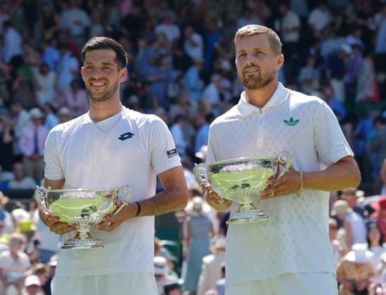 Tennis - 2025 Wimbledon Championships - Mens Doubles Final - Winky Hijikata and David Pel v Julian Cash and Lloyd Glasspool All England Lawn Tennis & Croquet Club - Saturday 12th July 2025 Julian Cash and Lloyd Glasspool with their winners trophies 