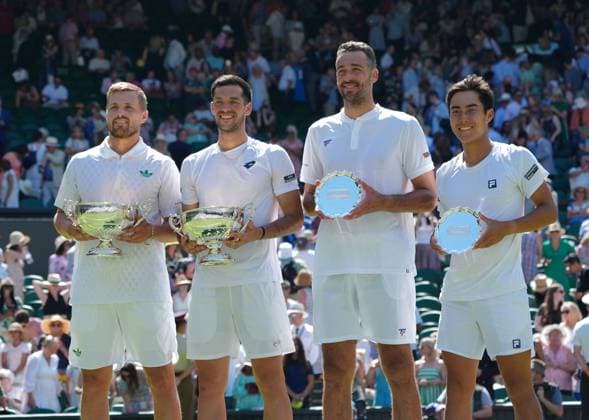 Tennis - 2025 Wimbledon Championships - Mens Doubles Final - Winky Hijikata and David Pel v Julian Cash and Lloyd Glasspool All England Lawn Tennis & Croquet Club - Saturday 12th July 2025 Julian Cash and Lloyd Glasspool with their winners trophies and Winky Hijikata and David Pel v Julian with their runners up trophies 