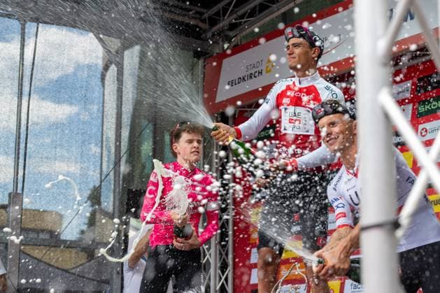 CYCLING - Tour of Austria 2025 FELDKIRCH,AUSTRIA,13.JUL.25 - CYCLING - Tour of Austria, stage 5, Feldkirch - Feldkirch. Image shows the podium of the tour 2025: Archie Ryan (IRL EF Education - Easypost), Isaac Del Torro Romero (MEX UAE Team Emirates XRG) and Rafal Majka (POL UAE Team Emirates XRG). Keywords: champaign shower.  GEPAxpictures xOliverxLerch