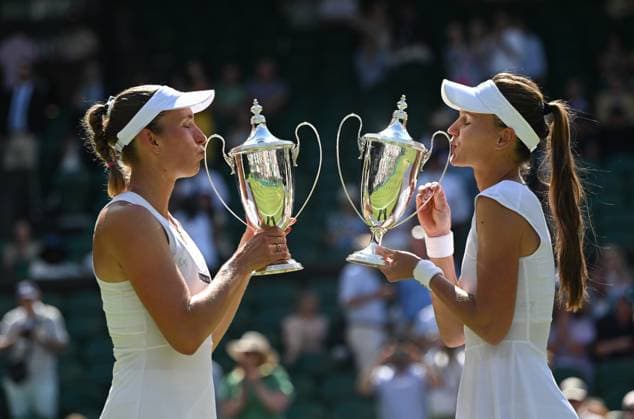 (250713) -- LONDON, July 13, 2025 -- Veronika Kudermetova Elise Mertens (L) kiss their trophies during the awarding ceremony after the women s doubles final between Hsieh Su-Wei (Chinese Taipei) Jelena Ostapenko (Latvia) and Veronika Kudermetova (Russia) Elise Mertens (Belgium) at the Wimbledon Tennis Championships in London, Britain, July 13, 2025. ) (SP)BRITAIN-LONDON-TENNIS-WIMBLEDON-WOMEN S DOUBLES-FINAL LixYing 