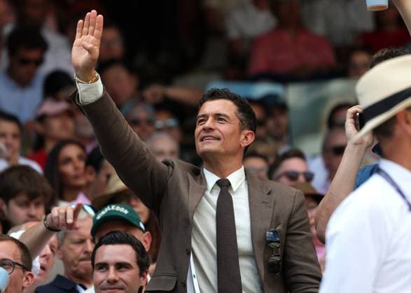 13th July 2025; All England Lawn Tennis and Croquet Club, London, England; Wimbledon Tennis Tournament, Day 14; Hollywood actor Orlando Bloom waving to a friend Niall in the stands watching Centre Court Gentlemen& x2019;s Single Final between Jannik Sinner (ITA) vs Carlos Alcaraz (ESP)  ActionPlus12813423 JohnxPatrickxFletcher
