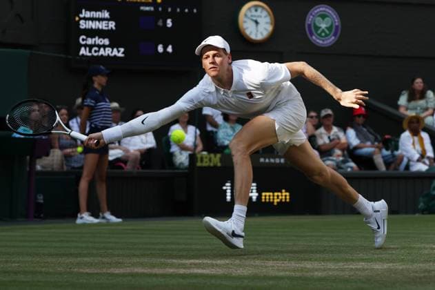 Italian Jannik Sinner plays a forehand during the Wimbledon Men s Singles Final against Spain s Carlos Alcaraz on day fourteen of the 2025 Wimbledon Championships in London on Sunday, July 13, 2025.  LON2025071331 HUGOxPHILPOTT