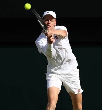 Italian Jannik Sinner plays a backhand during the Wimbledon Men s Singles Final against Spain s Carlos Alcaraz on day fourteen of the 2025 Wimbledon Championships in London on Sunday, July 13, 2025.  LON2025071362 HUGOxPHILPOTT