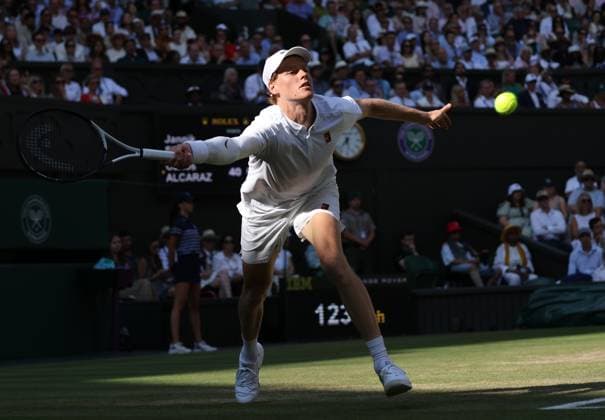 Italian Jannik Sinner plays a forehand during the Wimbledon Men s Singles Final against Spain s Carlos Alcaraz on day fourteen of the 2025 Wimbledon Championships in London on Sunday, July 13, 2025.  LON2025071344 HUGOxPHILPOTT