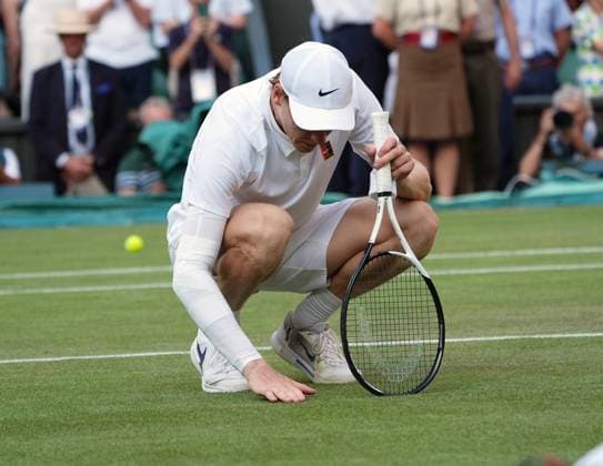 Tennis - 2025 Wimbledon Championships - Mens singles Final - Jannik Sinner (Italy) v Carlos Alcaraz (Spain) All England Lawn Tennis & Croquet Club - Sunday 13th July 2025 Jannik Sinner (Italy) drops to his knees after winning the match to feel the grass 