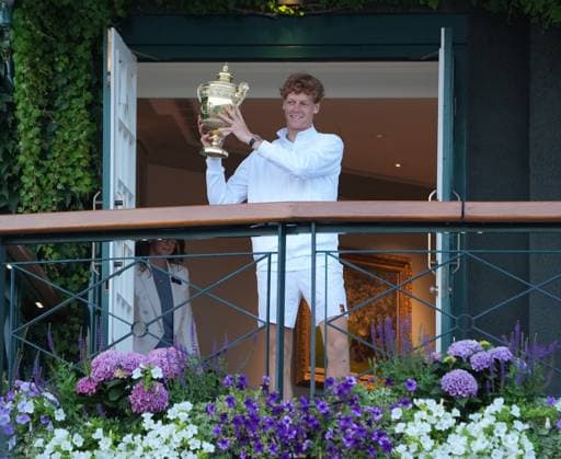 Tennis - 2025 Wimbledon Championships - Mens singles Final - Jannik Sinner (Italy) v Carlos Alcaraz (Spain) All England Lawn Tennis & Croquet Club - Sunday 13th July 2025 Jannik Sinner (Italy) comes out onto the Balcony to his cheering fans with the trophy 