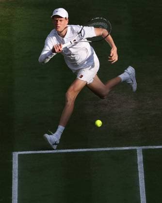 Italian Jannik Sinner plays a forehand during the Wimbledon Men s Singles Final against Spain s Carlos Alcaraz on day fourteen of the 2025 Wimbledon Championships in London on Sunday, July 13, 2025.  LON20250713115 HUGOxPHILPOTT