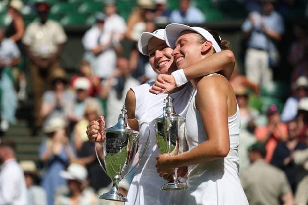 13th July 2025; All England Lawn Tennis and Croquet Club, London, England; Wimbledon Tennis Tournament, Day 14; Veronika Kudermetova (RUS) and Elise Mertens (BEL) hugging each other while they hold the Ladies Doubles Trophies after defeating Su-Wei Hsieh (TPE) and Jelena Ostapenko (AUT) 3-6 6-2 6-4  ActionPlus12813556 JohnxPatrickxFletcher