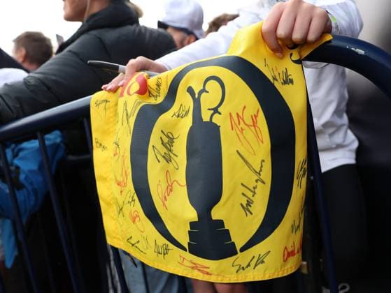 15th July 2025; Royal Portrush Golf Club, Portrush, County Antrim, Northern Ireland; The Open Golf Championship Practice Day 3; a fan holds a flag autographed by players at the 18th hole  ActionPlus12814095 DavidxBlunsden
