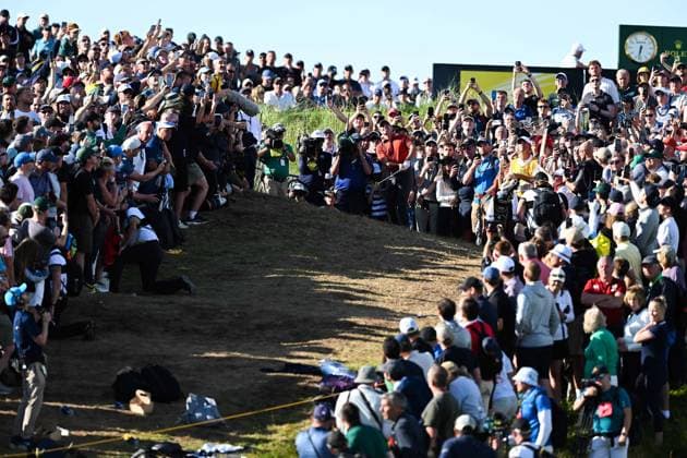 Rory McIlroy plays a shot over massive crowds on the 17th fairway after playing from within the spectator embankment The Open Championship, Day Three, Golf, Royal Portrush Golf Club, Portrush, Northern Ireland, UK - 19 Jul 2025 EDITORIAL USE ONLY No use with unauthorised audio, video, data, fixture lists, club league logos or live services. Online in-match use limited to 120 images, no video emulation. No use in betting, games or single club league player publications. Copyright: xGreigxCowie Shutterstockx 15403239an