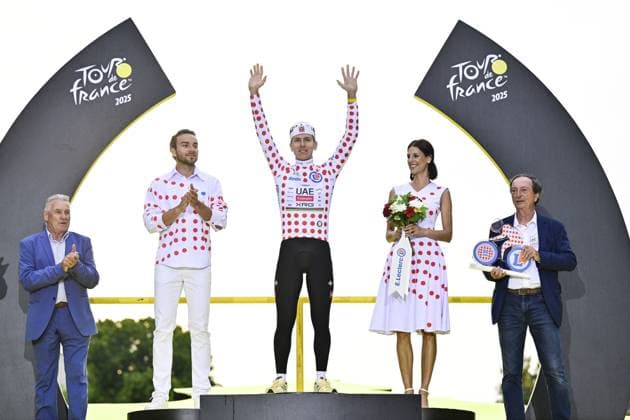 Slovenian Tadej Pogacar of UAE Team Emirates celebrates on the podium in the red polka-dot jersey for best climber with former Belgian pro rider and last Belgian winner of the Tour Lucien Van Impe after stage 21 of the 2025 Tour de France cycling race, from Mantes-la-Ville to Paris (120km), on Sunday 27 July 2025 in France. The 112th edition of the Tour de France starts on Saturday 5 July in Lille, France, and will finish in Paris, France on the 27th of July. DIRKxWAEM  x130135087x