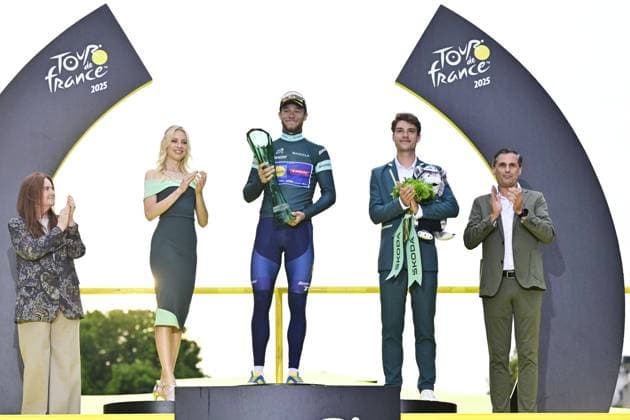 Italian Jonathan Milan of Lidl-Trek celebrates on the podium in the green jersey of leader in the sprint ranking after stage 21 of the 2025 Tour de France cycling race, from Mantes-la-Ville to Paris (120km), on Sunday 27 July 2025 in France. The 112th edition of the Tour de France starts on Saturday 5 July in Lille, France, and will finish in Paris, France on the 27th of July. DIRKxWAEM  x130137336x