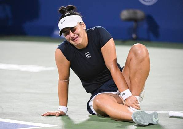 July 27, 2025, Montreal, Pq, Canada: Bianca Andreescu, of Canada, holds her ankle following a fall during her first round match against Barbora Krejcikova, of the Czech Republic, at the National Bank Open tennis tournament in Montreal, Sunday, July 27, 2025. Barbora Krejcikova, Bianca Andreescu, - ZUMAc35_ 20250727_zaf_c35_062 Copyright: xGrahamxHughesx