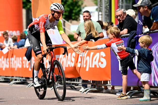 Tour de Wallonie 2025 Stage 4 SERAING, BELGIUM - JULY 29 : Rider of Intermarche - Wanty with a young fan of Lotto before the start of the race during stage 4 of the 30th edition of Tour de Wallonie an UCI ProSeries 2.Pro cycling road race stage for Men Elite of 163.3 km with start in Welkenraedt and finish in Seraing on July 29, 2025 in Seraing, Belgium, 29 07 2025 ( Motordriver Louis Bidlot - Seraing Belgium  Copyright: xTomasxSiskx