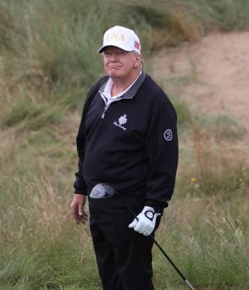 American President Donald Trump reacts after hitting the first ball at The New Course at Trump International Links, Aberdeen in Scotland on Tuesday, July 29, 2025. Trump is on a four day visit to Scotland where he will be playing golf and meeting International leaders for trade discussions.  LON2025072930 HUGOxPHILPOTT
