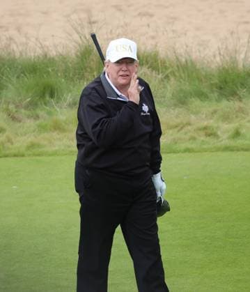 American President Donald Trump reacts after hitting the first ball at The New Course at Trump International Links, Aberdeen in Scotland on Tuesday, July 29, 2025. Trump is on a four day visit to Scotland where he will be playing golf and meeting International leaders for trade discussions.  LON2025072909 HUGOxPHILPOTT