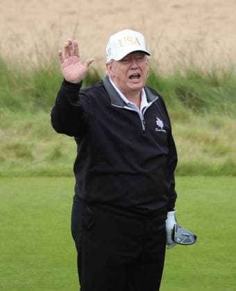 American President Donald Trump reacts after hitting the first ball at The New Course at Trump International Links, Aberdeen in Scotland on Tuesday, July 29, 2025. Trump is on a four day visit to Scotland where he will be playing golf and meeting International leaders for trade discussions.  LON2025072913 HUGOxPHILPOTT