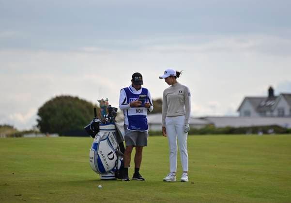30th July 2025; Royal Porthcawl Golf Club, Porthcawl, Wales; AIG Womens Open Golf, Practice Day; Yealimi Noh and her caddy reading the green book on the 1st hole  AledxHopkins