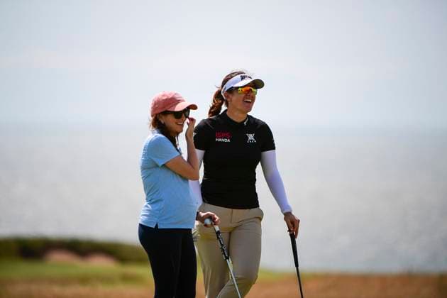 30th July 2025; Royal Porthcawl Golf Club, Porthcawl, Wales; AIG Womens Open Golf, Practice Day; Hannah Green laughing with playing partner on the 18th green  AledxHopkins