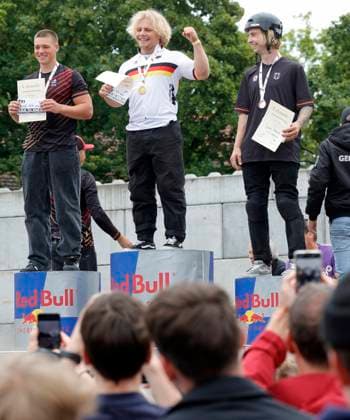 03 08 2025 BMX German Freestyle Championship 2025 in Park and Flatland at Bikepark Darmstadt here award ceremony Freestyle Park Elite with Julius KNAPP 2nd place Philipp MUTH with too small jacket 1st place Dean FLORIAN 3rd place awards gold medal national coach Mark König Darmstadt Hesse Germany