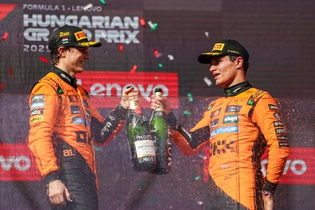(250804) -- BUDAPEST, Aug. 4, 2025 -- First placed McLaren s British driver Lando Norris (R) and second placed McLaren s Australian driver Oscar Piastri celebrate during the awarding ceremony after the race of the Formula One Hungarian Grand Prix at the Hungaroring in Mogyorod, near Budapest, Hungary, on Aug. 3, 2025. (Photo by Xinhua) (SP)HUNGARY-MOGYOROD-F1-HUNGARIAN GRAND PRIX-RACE QianxJun 