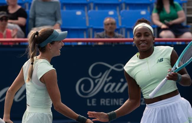 (250804) -- MONTREAL, Aug. 4, 2025 -- Coco Gauff (R) high-fives with McCartney Kessler during the women s doubles quarter-final match between Coco Gauff McCartney Kessler of the United States and Barbora Krejcikova (Czech Republic) Jelena Ostapenko (Latvia) at the 2025 National Bank Open tennis tournament in Montreal, Canada, Aug 3, 2025. (Photo by Xinhua) (SP)CANADA-MONTREAL-TENNIS-NATIONAL BANK OPEN-WOMEN S DOUBLES LixHaitao 