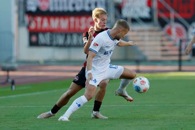f l Tim Janisch 1 FC Nuernberg, 32 and Fabian Nuernberger SV Darmstadt, 15 08 08 2025, Soccer, 2 Bundesliga, 1 FC Nuernberg SV Darmstadt 98, GER, Nuernberg, Max Morlock Stadion, DFL REGULATIONS PROHIBIT ANY USE OF PHOTOGRAPHS AS IMAGE SEQUENCES AND OR QUASI VIDEO Copyright: HMBxMedia xHeikoxBecker