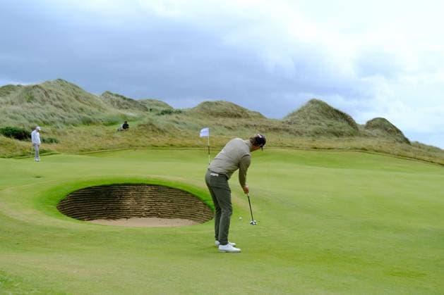 UK: Nexo Championship, Old Course at Trump International Golf Links, Aberdeen, Scotland on 08 August 2025: Pictured: Wil Besseling (Netherlands) putts past a bunker on the 13th green during the second round of the Nexo Championship 2025 at Trump International Golf Links, Aberdeenshire, Scotland Aberdeen Trump International Golf Links Scotland Copyright: xAlexxToddx