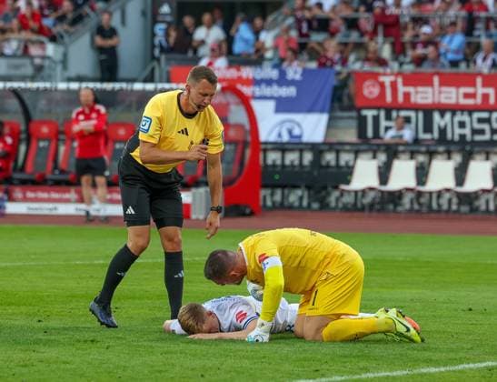 Clemens Riedel 38 SV Darmstadt 98 lies injured on the ground, referee referee Florian Lechner and Marcel Schuhen 1 SV Darmstadt 98 take care of him, 1 FC Nuernberg vs SV Darmstadt 98, DFL, 2 Bundesliga, Saison 2025 2026, 2 Spieltag, Hinrunde, 08 08 2025 DFB regulations prohibit any use of photographs as image sequences and or quasi video Nuernberg Bayern Germany Copyright: xkolbert-press MartinxAgüerax